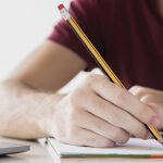 Hiking woman with backpack walking on a gravel road